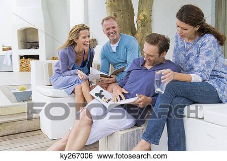 Four friends having fun at home View Large Photo Image Stock Photograph - Four friends having fun at home. Fotosearch