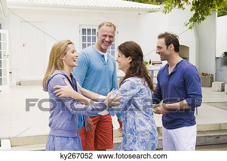 Two couples smiling together View Large Photo Image Stock Image - Two couples smiling together. Fotosearch