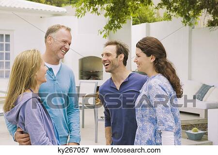 Two couples smiling together View Large Photo Image Stock Photo - Two couples smiling together. Fotosearch