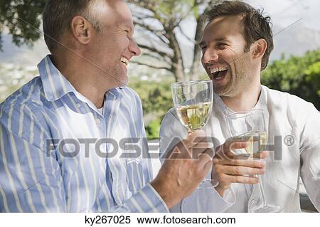 Two friends drinking white wine View Large Photo Image Stock Photography - Two friends drinking white wine. Fotosearch