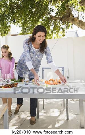 Woman having breakfast with her daughter at the dining table View Large Photo Image Stock Image - Woman having breakfast with her daughter at the dining table. Fotosearch