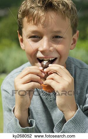 Boy eating a candy View Large Photo Image Stock Image - Boy eating a candy. Fotosearch