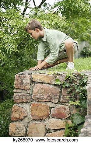 Boy playing in a garden View Large Photo Image Stock Image - Boy playing in a garden. Fotosearch