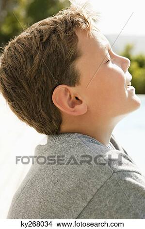 Close-up of a boy day dreaming View Large Photo Image Picture - Close-up of a boy day dreaming. Fotosearch