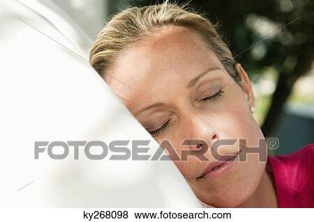Stock Photo - Close-up of a woman napping. Fotosearch