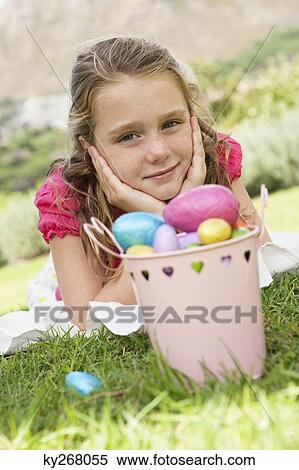 Container of Easter eggs in front of a girl View Large Photo Image Stock Photography - Container of Easter eggs in front of a girl. Fotosearch