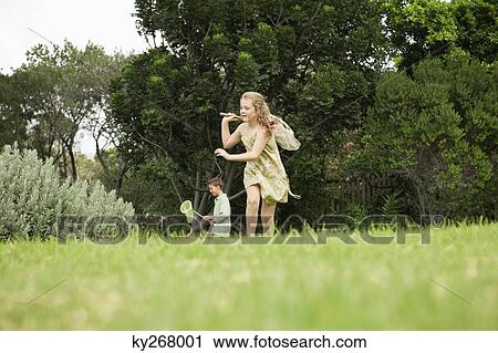 Girl and a boy playing with butterfly nets in a garden View Large Photo Image Stock Image - Girl and a boy playing with butterfly nets in a garden. Fotosearch
