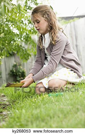 Girl gardening with a shovel View Large Photo Image Stock Image - Girl gardening with a shovel. Fotosearch