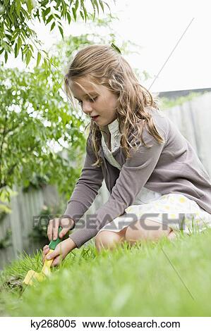 Girl gardening with a trowel View Large Photo Image Stock Photography - Girl gardening with a trowel. Fotosearch