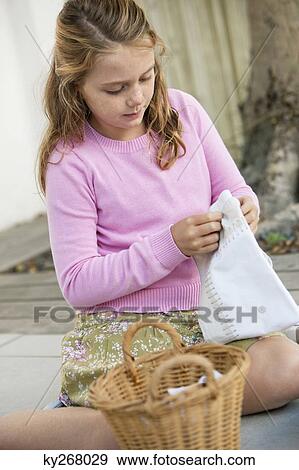 Girl holding a pillow cover View Large Photo Image Stock Photo - Girl holding a pillow cover. Fotosearch