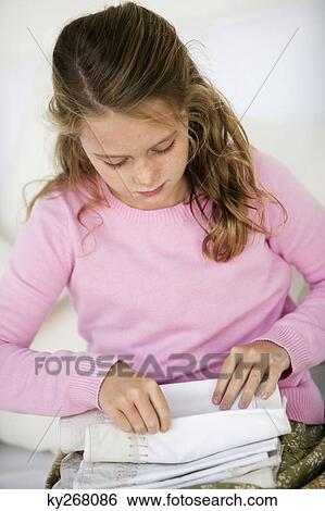 Stock Photograph - Girl holding pillow covers. Fotosearch