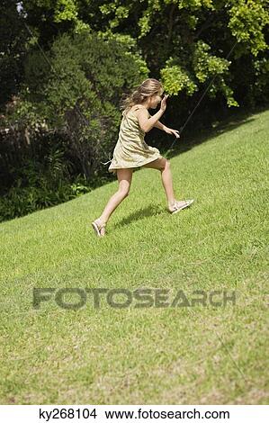 Girl playing in a garden View Large Photo Image Picture - Girl playing in a garden. Fotosearch