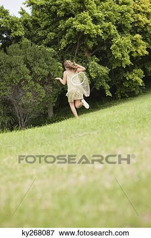 Girl playing with a butterfly net in a garden View Large Photo Image Stock Photo - Girl playing with a butterfly net in a garden. Fotosearch