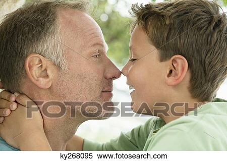 Stock Photography - Man and his son rubbing noses. Fotosearch