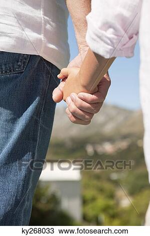 Stock Image - Man holding his son's hand. Fotosearch