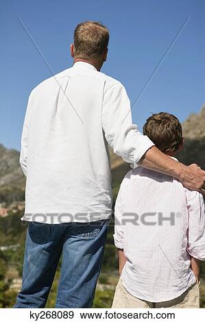 Stock Photo - Man standing with his son. Fotosearch