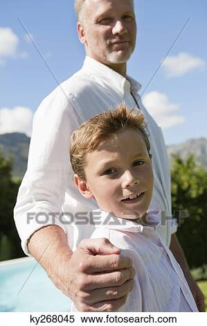 Stock Photography - Man standing with his son. Fotosearch