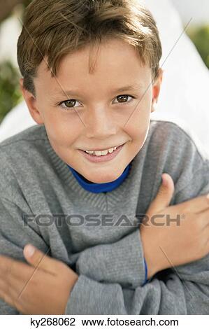 Portrait of a boy hugging himself View Large Photo Image Stock Image - Portrait of a boy hugging himself. Fotosearch
