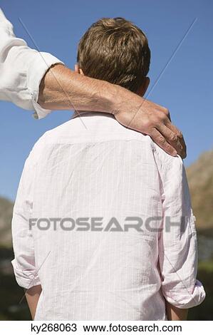 Rear view of a boy with his father View Large Photo Image Stock Image - Rear view of a boy with his father. Fotosearch