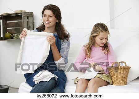Woman and her daughter holding pillow covers View Large Photo Image Stock Image - Woman and her daughter holding pillow covers. Fotosearch