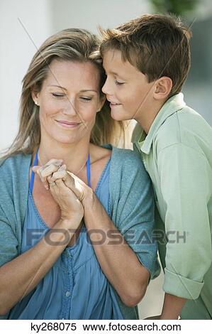 Stock Photography - Woman smiling with her son. Fotosearch