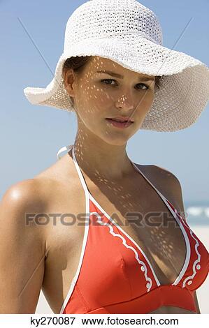 Portrait of a woman standing on the beach View Large Photo Image Stock Photo - Portrait of a woman standing on the beach. Fotosearch