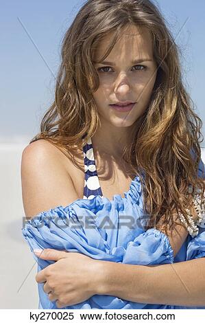 Portrait of a woman standing on the beach View Large Photo Image Stock Photography - Portrait of a woman standing on the beach. Fotosearch