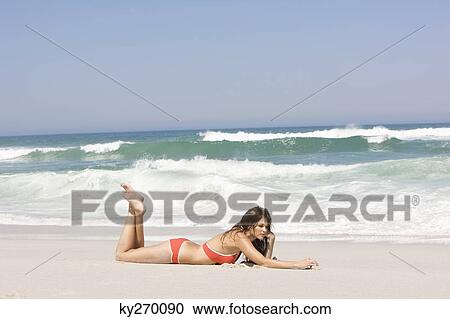Woman lying on the beach View Large Photo Image Stock Image - Woman lying on the beach. Fotosearch