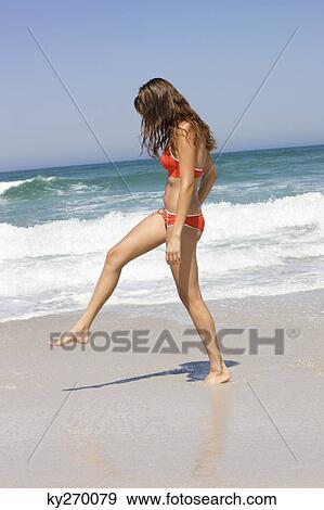 Woman walking on the beach View Large Photo Image Stock Photo - Woman walking on the beach. Fotosearch