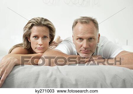 Couple lying on the bed View Large Photo Image Stock Image - Couple lying on the bed. Fotosearch