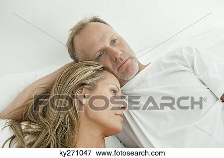 Stock Photo - Couple resting on the bed. Fotosearch
