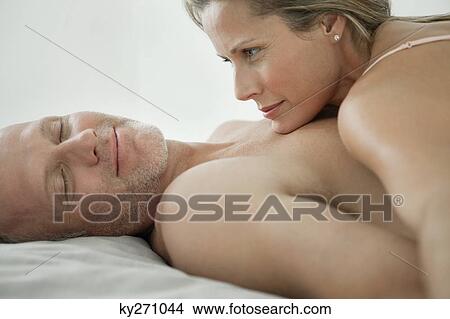 Couple romancing on the bed View Large Photo Image Picture - Couple romancing on the bed. Fotosearch