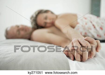 Stock Image - Couple romancing on the bed. Fotosearch