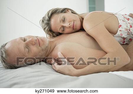 Stock Photo - Couple romancing on the bed. Fotosearch