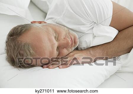 Man sleeping on the bed View Large Photo Image Stock Image - Man sleeping on the bed. Fotosearch