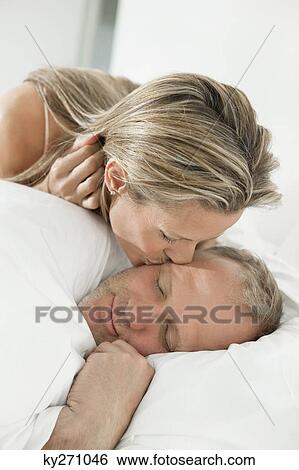 Woman kissing a man View Large Photo Image Stock Photograph - Woman kissing a man. Fotosearch