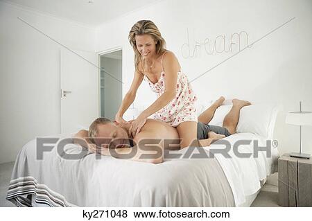 Stock Photo - Woman massaging back of a man. Fotosearch