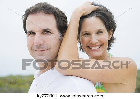 Close-up of a couple smiling View Large Photo Image Stock Image - Close-up of a couple smiling. Fotosearch