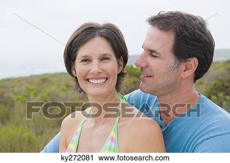 Close-up of a couple smiling View Large Photo Image Stock Image - Close-up of a couple smiling. Fotosearch