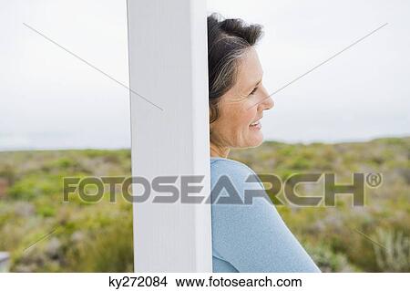 Picture - Close-up of a woman day dreaming. Fotosearch