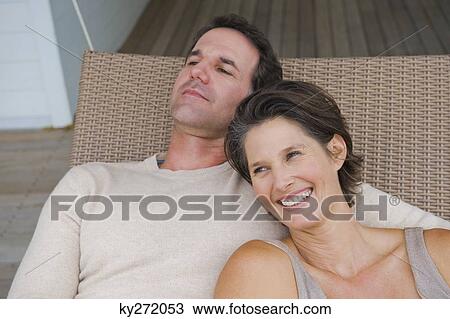 Couple resting on a porch swing View Large Photo Image Stock Image - Couple resting on a porch swing. Fotosearch