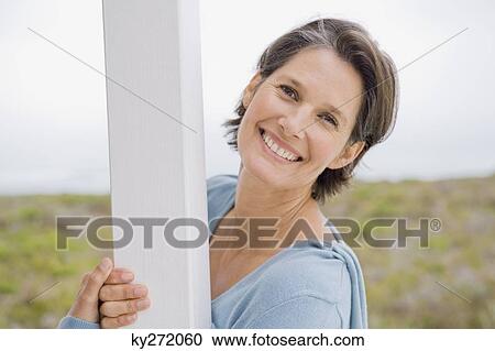 Stock Image - Portrait of a woman smiling. Fotosearch