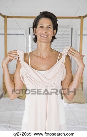 Portrait of a woman trying on a dress View Large Photo Image Stock Photography - Portrait of a woman trying on a dress. Fotosearch