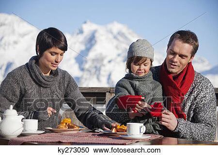 Couple and daughter eating on balcony at ski resort View Large Photo Image Stock Image - Couple and daughter eating on balcony at ski resort. Fotosearch