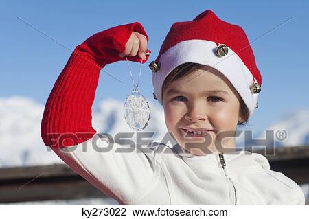 Girl wearing Santa hat, playing View Large Photo Image Stock Image - Girl wearing Santa hat, playing. Fotosearch