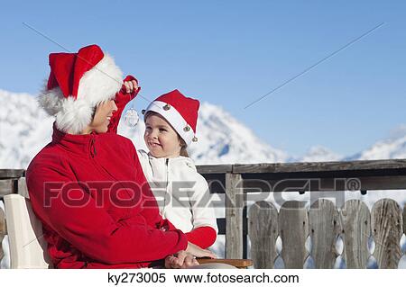 Mother and dauhter wearing Santa hats, playing View Large Photo Image Stock Photography - Mother and dauhter wearing Santa hats, playing. Fotosearch