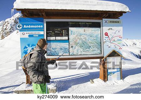 Male skier looking at map, Courchevel, France View Large Photo Image Stock Photo - Male skier looking at map, Courchevel, France. Fotosearch