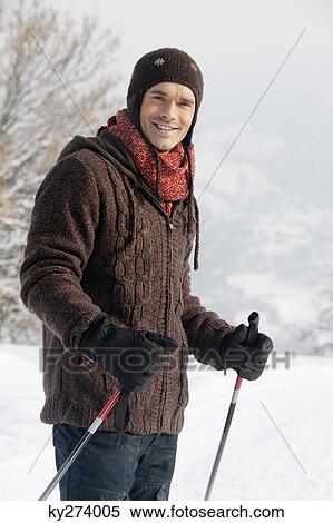 Stock Photography - Male skier smiling at camera. Fotosearch
