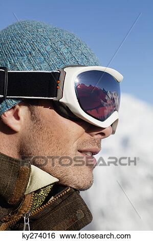Stock Photograph - Portrait of man with ski goggles, profile. Fotosearch