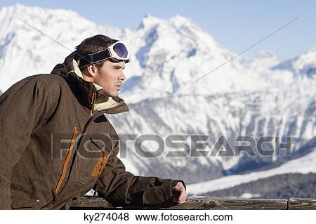 Young man in ski wear day dreaming View Large Photo Image Stock Photo - Young man in ski wear day dreaming. Fotosearch